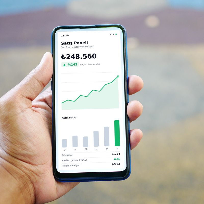 Phone screen showing a sales dashboard with a rising chart